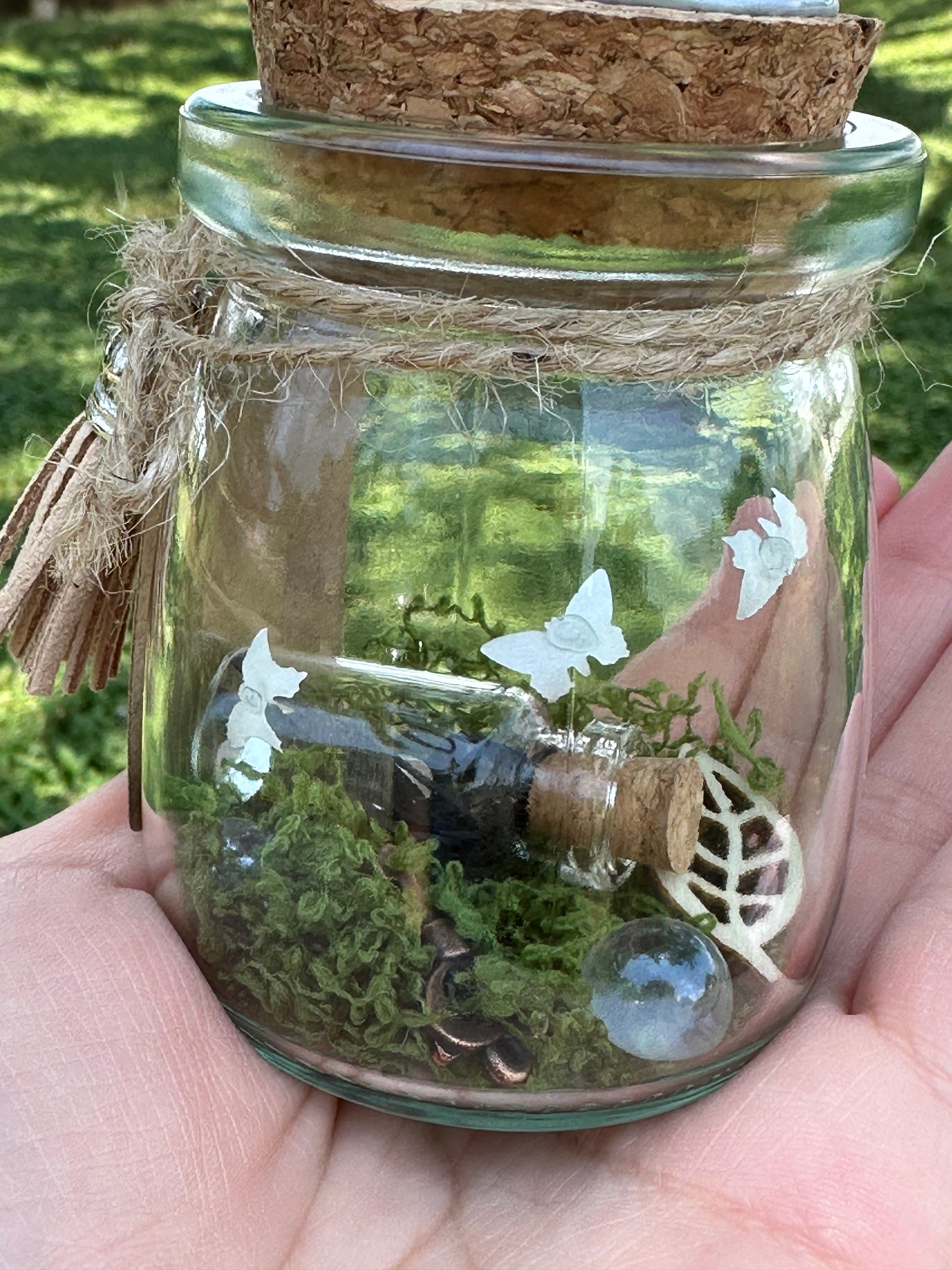 Detail picture of black wish bottle with leaves and jewels