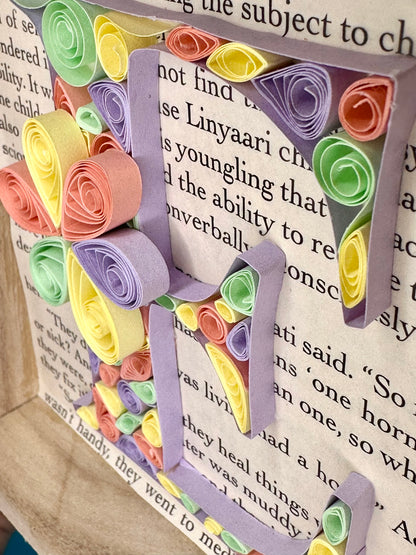 Close up of abstract quilling letter E