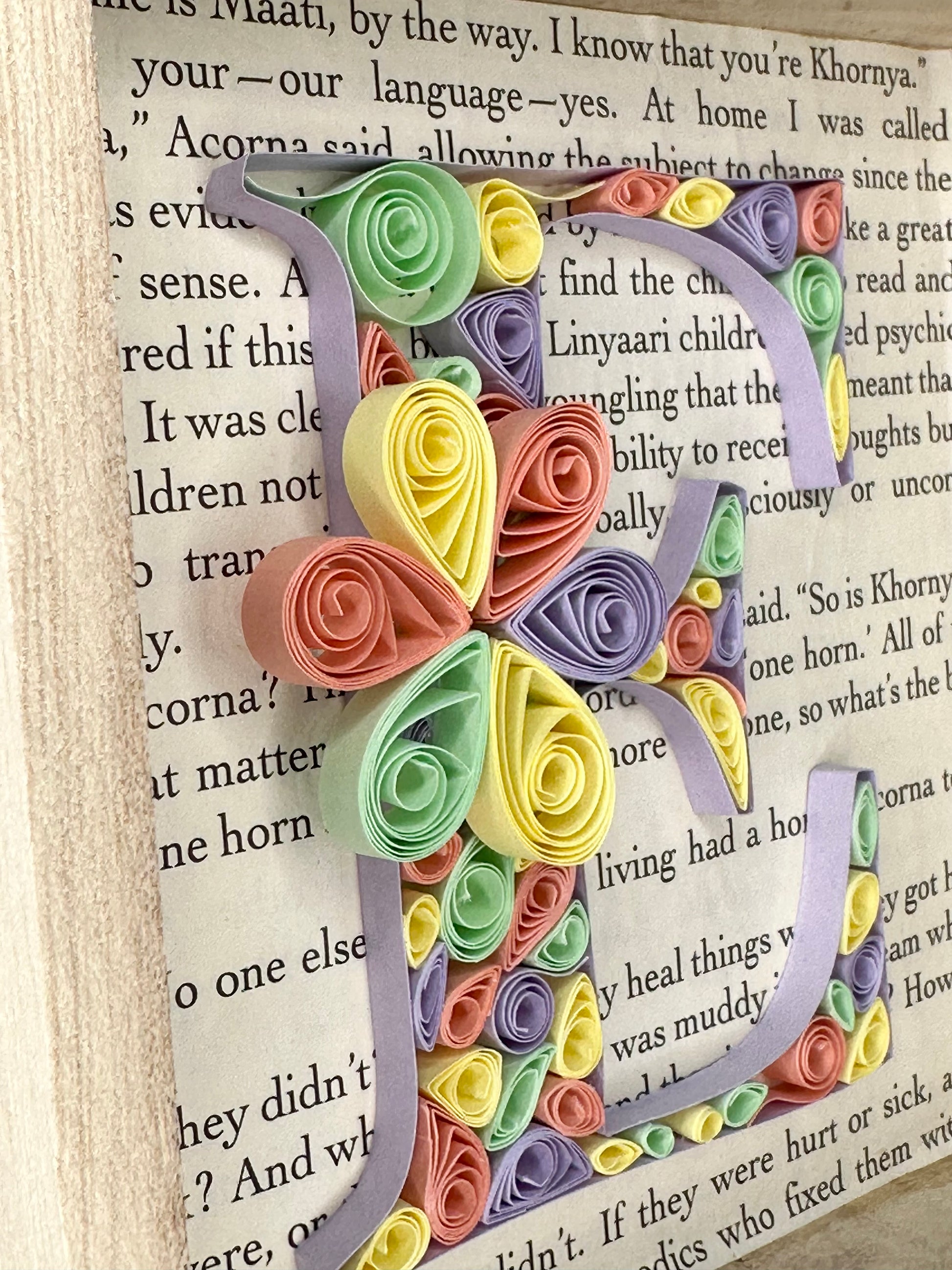 Quilling letter E with abstract design