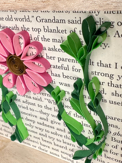 Close up picture of leaves and pink flower