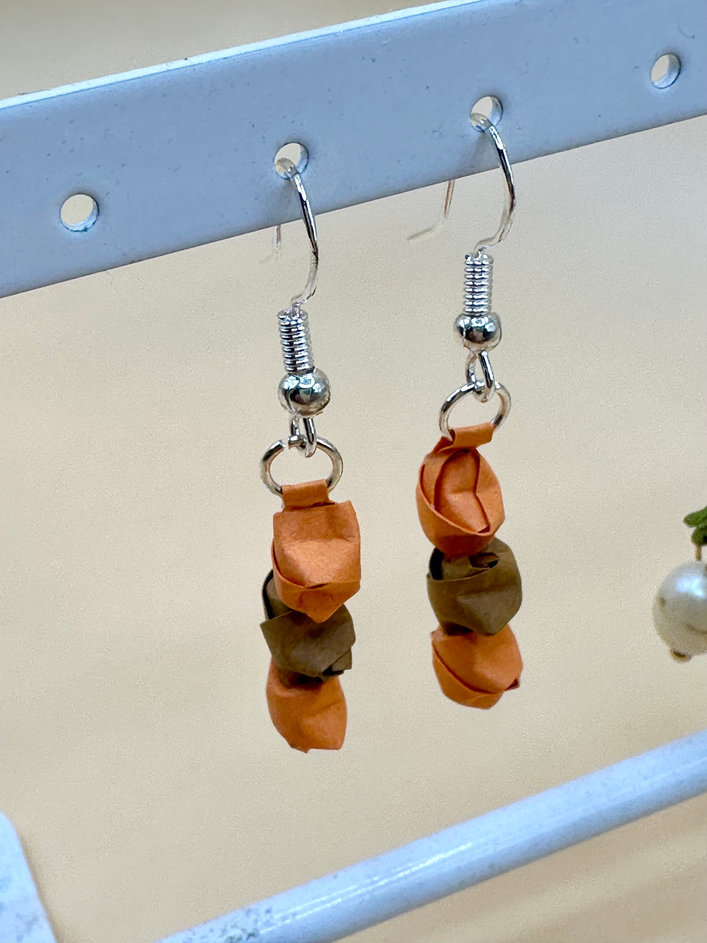 Close up of orange origami earrings